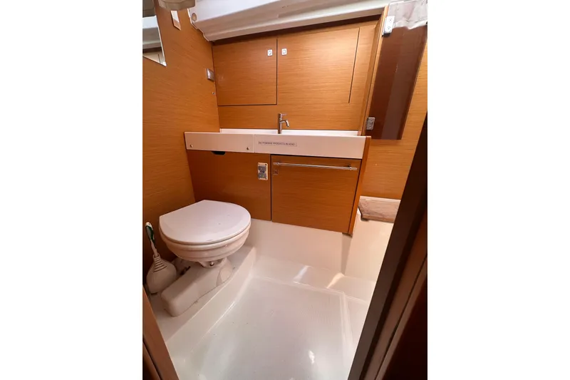 Slide: The Image of 2015 Jeanneau Sun Odyssey 469 bathroom with wooden cabinetry and modern fixtures. - 31