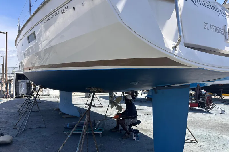 Slide: The Image of 2015 Jeanneau Sun Odyssey 469 sailboat undergoing maintenance in a shipyard. - 37