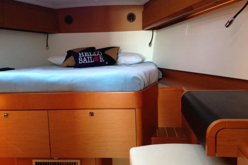 Slide: The Image of Interior cabin of 2015 Jeanneau Sun Odyssey 469 yacht with bed and "Hello Sailor" pillow. - 39