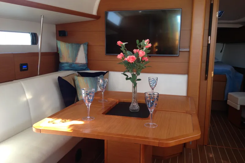 Slide: The Image of Interior of 2015 Jeanneau Sun Odyssey 469 yacht with elegant dining area and floral centerpiece. - 5