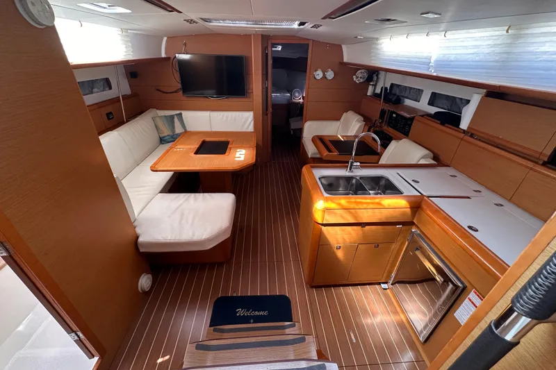 Slide: The Image of Interior of 2015 Jeanneau Sun Odyssey 469 yacht with modern kitchen and seating area. - 6