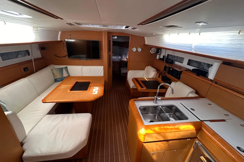 Slide: The Image of Interior of 2015 Jeanneau Sun Odyssey 469 yacht with modern kitchen and seating area. - 7