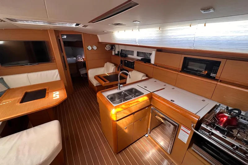 Slide: The Image of Luxurious interior of 2015 Jeanneau Sun Odyssey 469 yacht with modern kitchen amenities. - 8