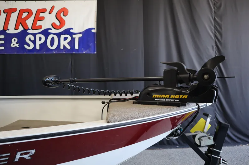 Slide: The Image of 2013 MirroCraft 1416 Troller boat with Minn Kota PowerDrive motor displayed indoors. - 7