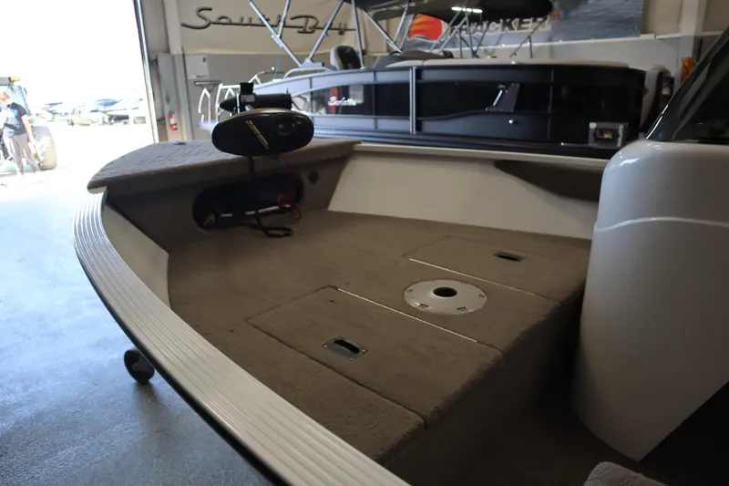 Slide: The Image of 2013 MirroCraft 1416 Troller boat interior with carpeted deck and trolling motor. - 9