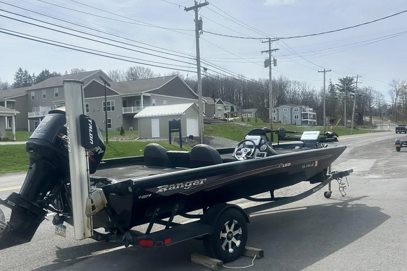 The Image of 2016 Ranger RT188 boat on trailer, parked on roadside near residential area. - 4