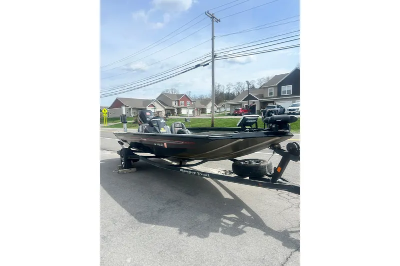 Slide: The Image of 2016 Ranger RT188 boat on trailer in suburban neighborhood street. - 7