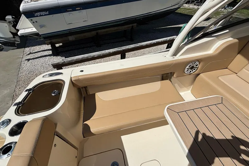 Slide: The Image of 2024 Scout 255 Dorado boat interior with tan seating and wood accents. - 12