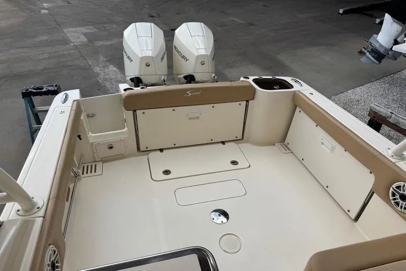Slide: The Image of 2024 Scout 255 Dorado boat deck with twin Mercury engines, spacious seating, and storage compartments. - 16