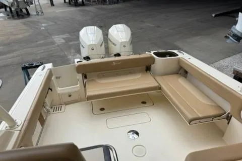 Slide: The Image of 2024 Scout 255 Dorado boat interior with dual engines and beige seating. - 17