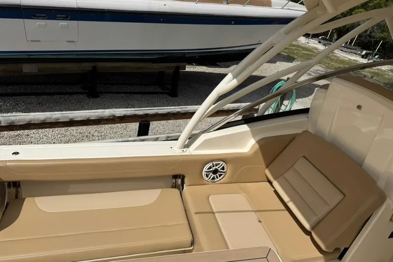 Slide: The Image of 2024 Scout 255 Dorado boat interior with tan seating and speaker detail. - 18
