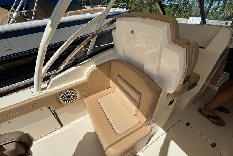 Slide: The Image of 2024 Scout 255 Dorado boat interior with tan seating and speaker detail. - 21