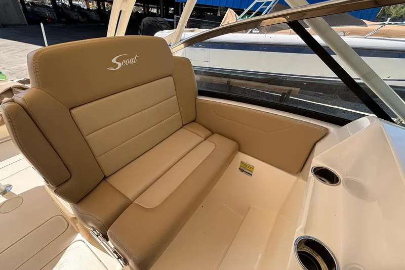 Slide: The Image of 2024 Scout 255 Dorado boat interior with tan leather seating and cup holders. - 22