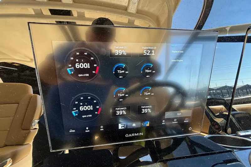 Slide: The Image of 2024 Scout 255 Dorado boat dashboard displaying engine metrics on a Garmin screen. - 27