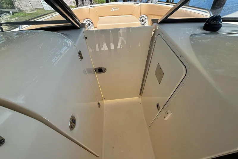 Slide: The Image of 2024 Scout 255 Dorado boat interior with seating and storage compartment. - 29