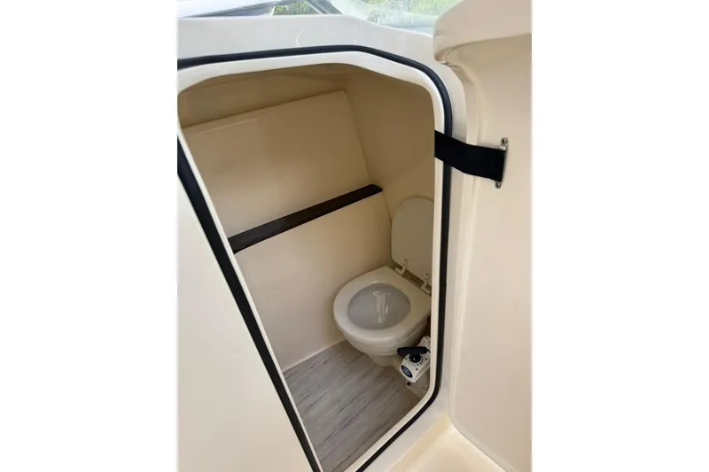 Slide: The Image of 2024 Scout 255 Dorado boat interior bathroom with toilet and compact design. - 30