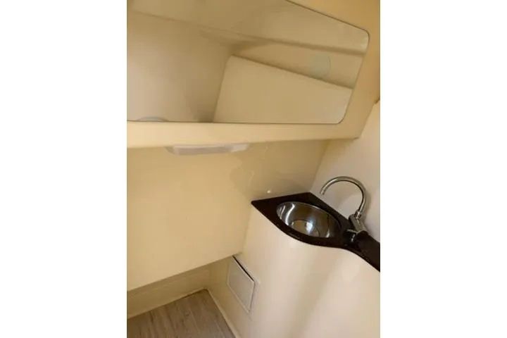 Slide: The Image of 2024 Scout 255 Dorado boat interior with sink and mirror. - 31