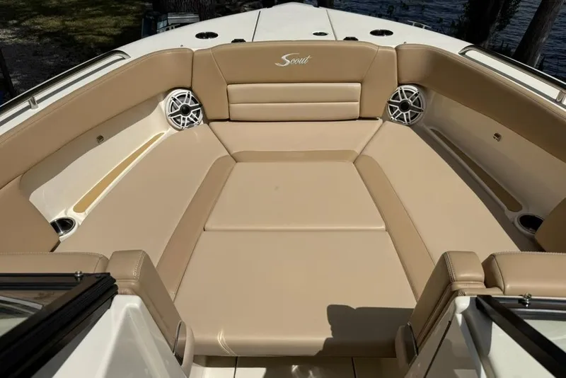 Slide: The Image of 2024 Scout 255 Dorado boat interior with tan seating and built-in speakers. - 34