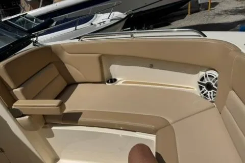 Slide: The Image of 2024 Scout 255 Dorado boat interior with beige seating and speaker. - 36
