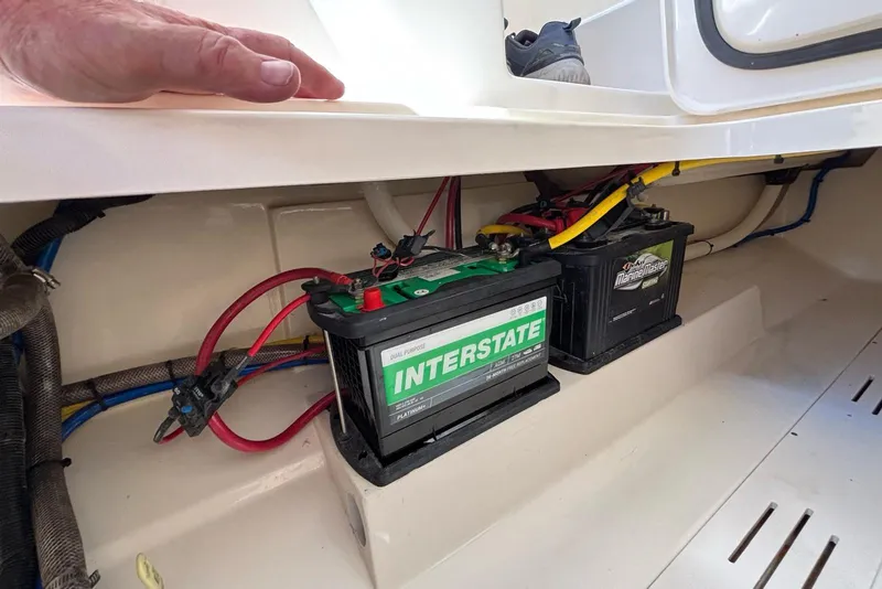Slide: The Image of 2024 Scout 255 Dorado boat battery compartment with Interstate and MarineMaster batteries. - 40