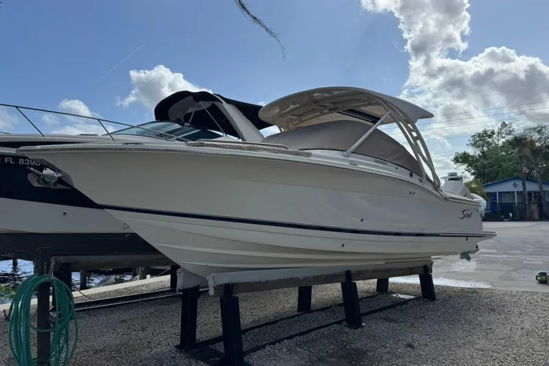 Slide: The Image of 2024 Scout 255 Dorado boat on display under a cloudy sky. - 48