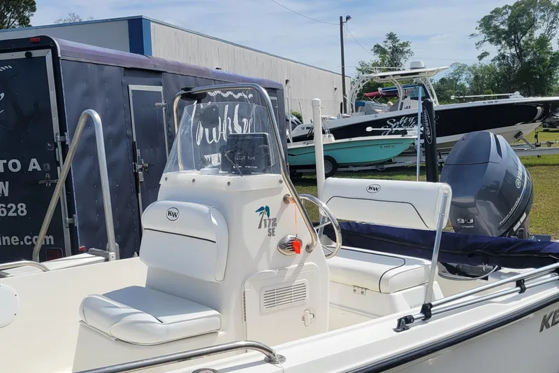 Slide: The Image of 2013 Key West 172 SE boat with Yamaha engine, parked outdoors near other boats. - 3