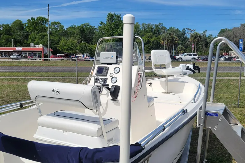 Slide: The Image of 2013 Key West 172 SE boat with Garmin navigation, parked outdoors on a sunny day. - 4
