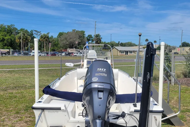 Slide: The Image of 2013 Key West 172 SE boat with Yamaha outboard motor, parked on grass. - 7