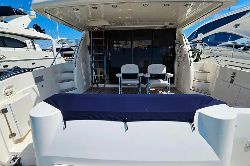 Slide: The Image of Sunseeker Manhattan 62 yacht deck, featuring seating and ladder, 1998 model. - 11