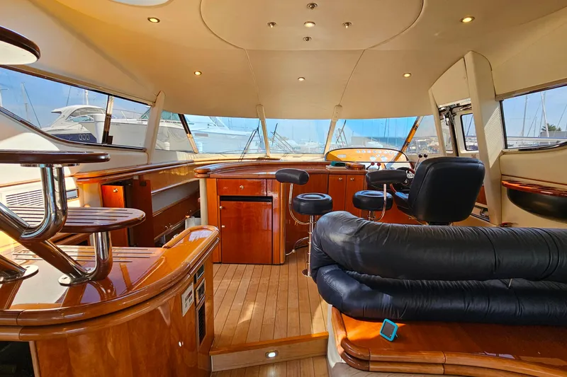 Slide: The Image of Luxurious interior of a 1998 Sunseeker Manhattan 62 yacht with polished wood and leather seating. - 17