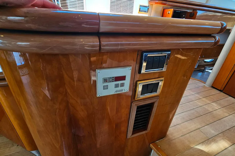 Slide: The Image of Interior of 1998 Sunseeker Manhattan 62 yacht with wooden paneling and control switches. - 19