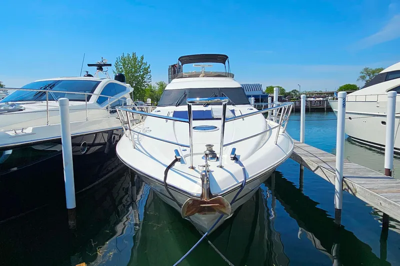 Slide: The Image of 1998 Sunseeker Manhattan 62 yacht docked at marina under clear blue sky. - 2