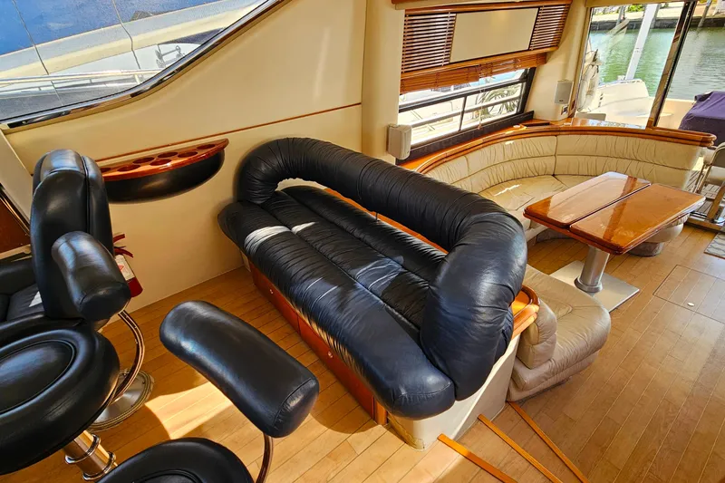 Slide: The Image of Luxurious interior of a 1998 Sunseeker Manhattan 62 yacht with leather seating and wooden accents. - 20