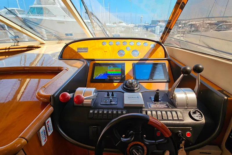 Slide: The Image of Cockpit of 1998 Sunseeker Manhattan 62 yacht with navigation controls and displays. - 21