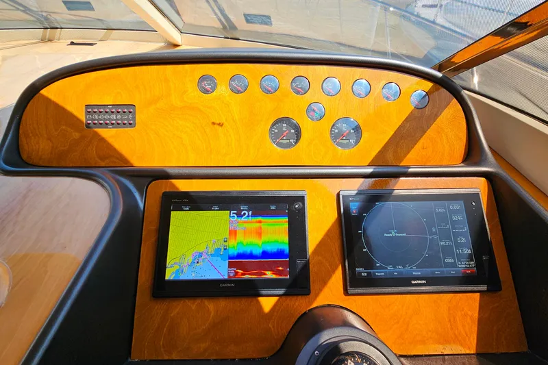 Slide: The Image of Control panel of a 1998 Sunseeker Manhattan 62 yacht with navigation screens. - 24