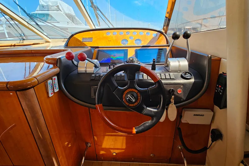 Slide: The Image of Cockpit of 1998 Sunseeker Manhattan 62 yacht with steering wheel and navigation controls. - 25