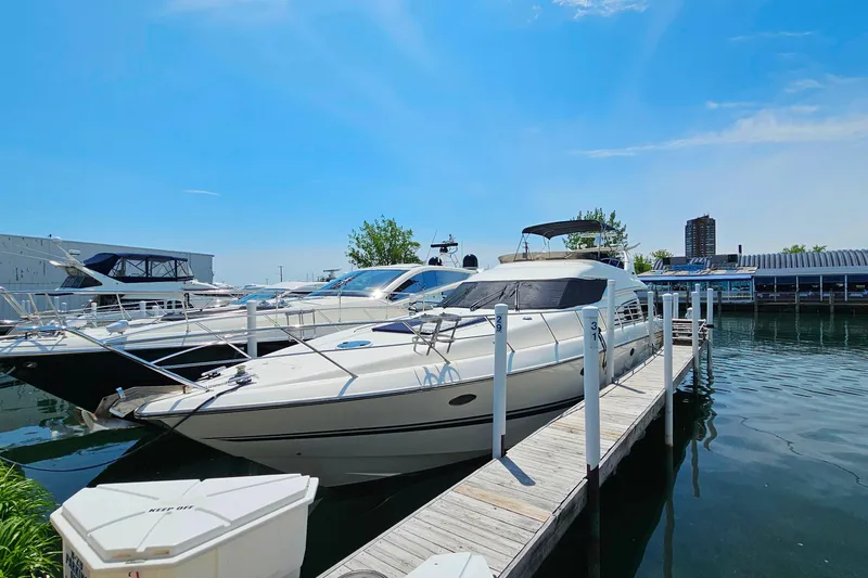 Slide: The Image of 1998 Sunseeker Manhattan 62 yacht docked at marina under clear blue sky. - 3