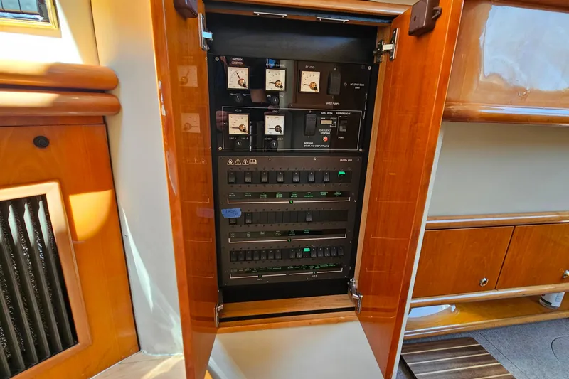 Slide: The Image of Electrical panel inside a 1998 Sunseeker Manhattan 62 yacht, showcasing circuit breakers and controls. - 30