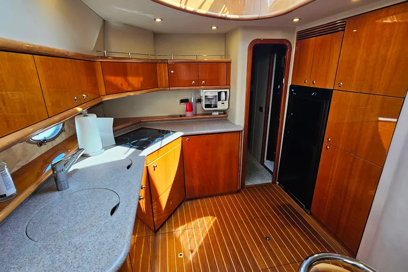 Slide: The Image of Luxurious kitchen interior of 1998 Sunseeker Manhattan 62 yacht with wooden cabinetry. - 31