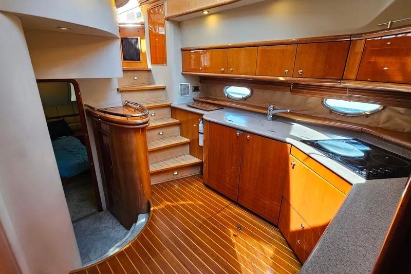 Slide: The Image of Luxurious interior of a 1998 Sunseeker Manhattan 62 yacht with wooden cabinetry and modern kitchen. - 32