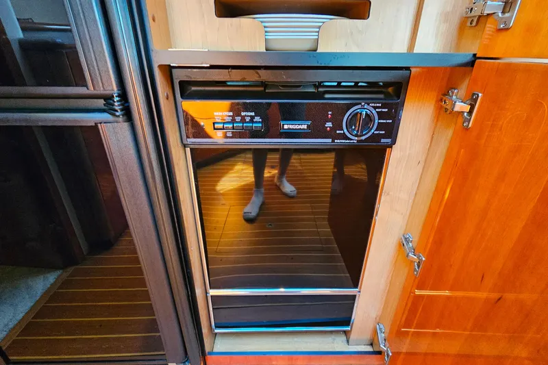Slide: The Image of Built-in Frigidaire dishwasher on 1998 Sunseeker Manhattan 62 yacht, wooden cabinetry. - 35