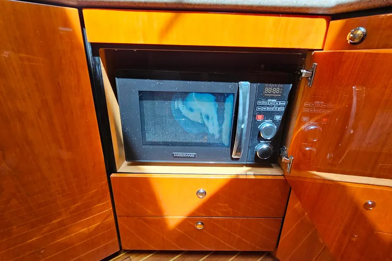 Slide: The Image of Microwave in Sunseeker Manhattan 62 yacht kitchen, 1998 model, with wooden cabinetry. - 36