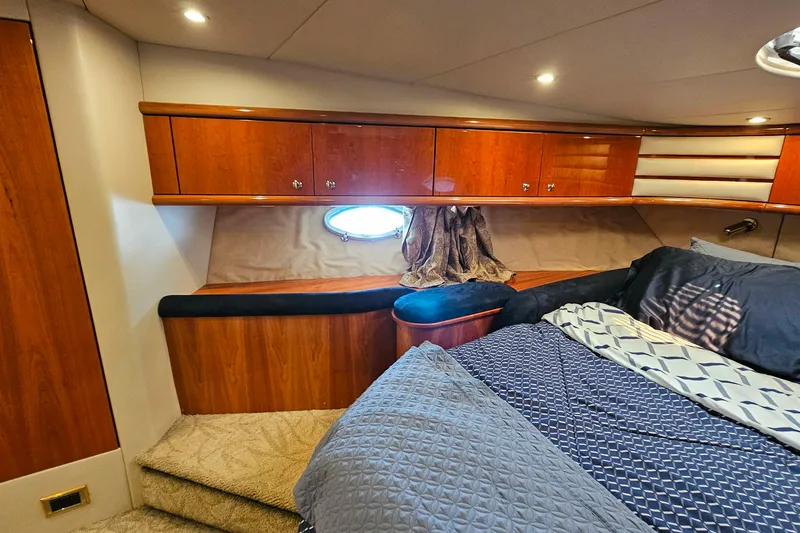 Slide: The Image of Luxurious cabin interior of 1998 Sunseeker Manhattan 62 yacht with wood finish and bedding. - 39