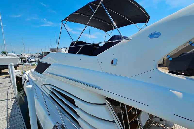 Slide: The Image of 1998 Sunseeker Manhattan 62 yacht docked at marina under clear blue sky. - 4