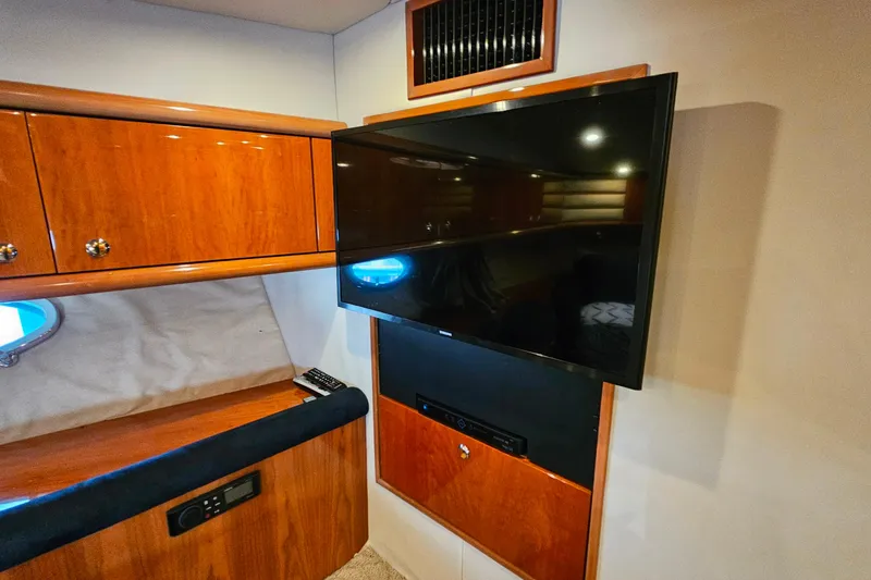 Slide: The Image of Interior of 1998 Sunseeker Manhattan 62 yacht with mounted TV and wooden cabinetry. - 40