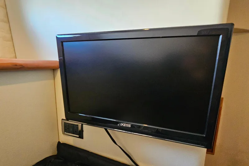 Slide: The Image of Flat-screen TV mounted inside a 1998 Sunseeker Manhattan 62 yacht cabin. - 49