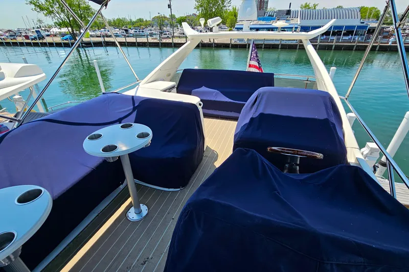 Slide: The Image of Flybridge of 1998 Sunseeker Manhattan 62 yacht with blue covers and cup holders. - 51