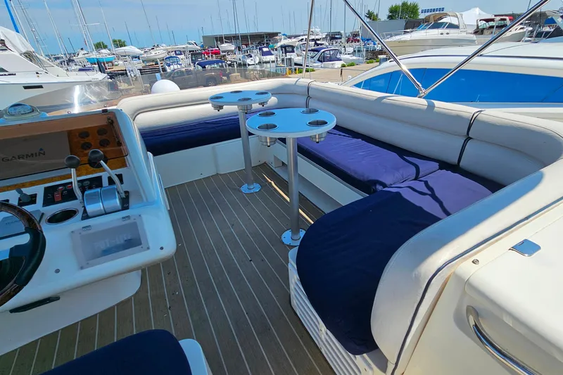 Slide: The Image of Flybridge of 1998 Sunseeker Manhattan 62 yacht with seating and control panel. - 53