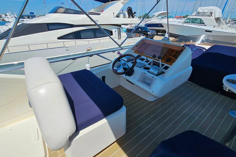 Slide: The Image of Cockpit of a 1998 Sunseeker Manhattan 62 yacht with steering wheel and controls. - 55