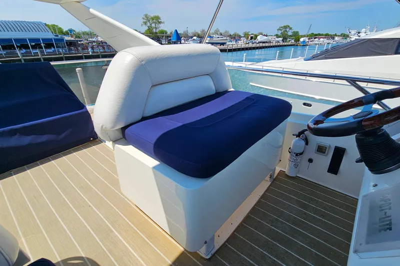 Slide: The Image of Captain's seat on 1998 Sunseeker Manhattan 62 yacht, overlooking marina. - 56